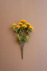 bundles of mustard colored faux zinnias