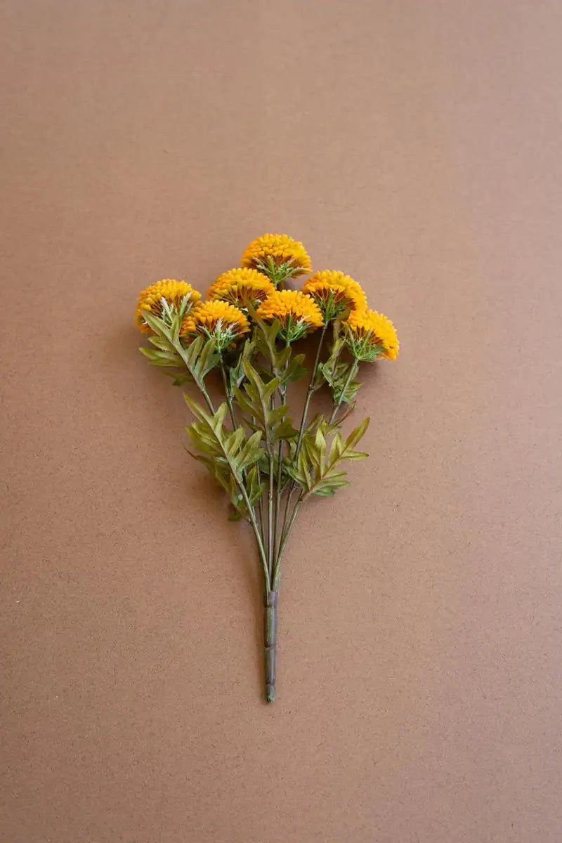 bundles of mustard colored faux zinnias