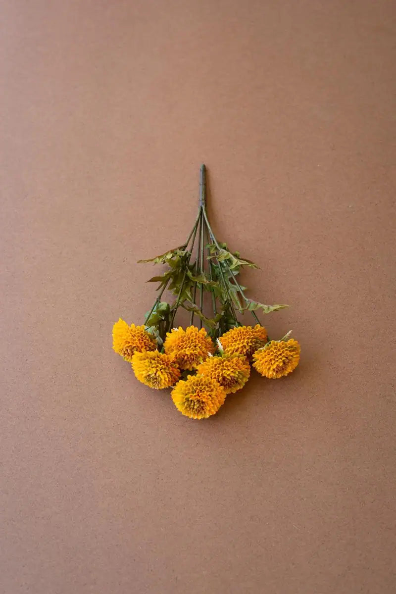 bundles of mustard colored faux zinnias - upside down