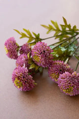 bundles of purple faux zinnias - angled close-up