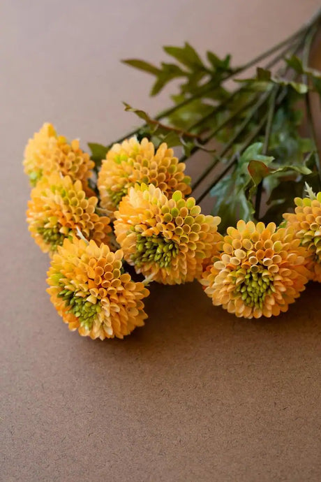 bundles of yellow faux zinnias - angled close-up