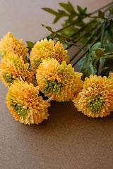 bundles of yellow faux zinnias - angled close-up 2