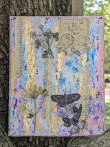 Original decorative mixed media canvas collage with floral, music and butterfly design held by tree trunk