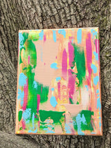 Colorful abstract painting against a tree trunk background in vivid colors