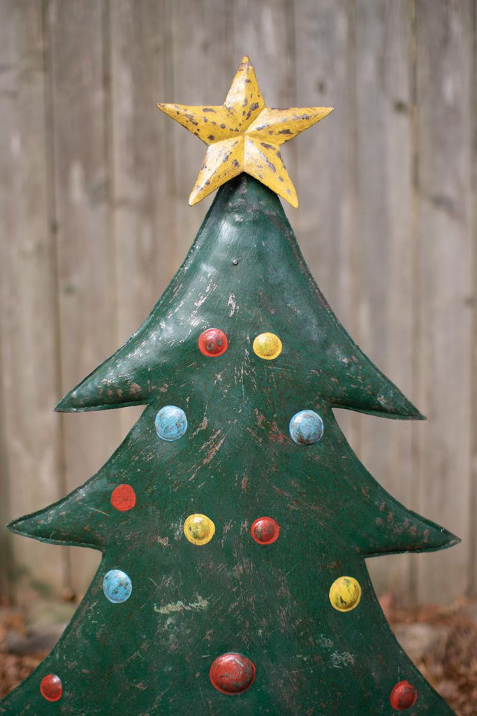 close-up of one tree, its gold star and simulated ornaments