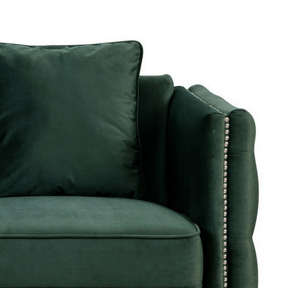 close-up of green sofa's arm rest and pillow