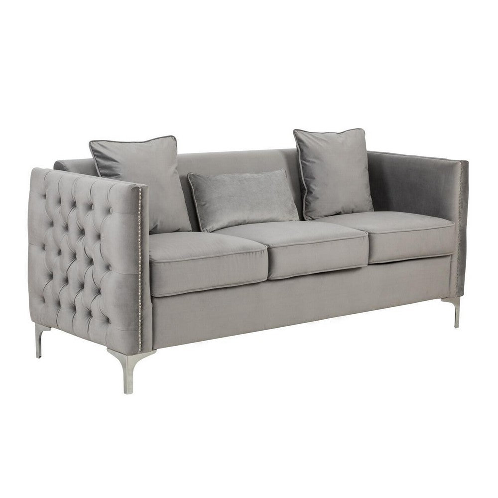 gray velvet sofa with three loose pillows