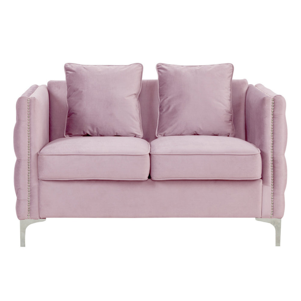 pink velvet loveseat with two loose pillows