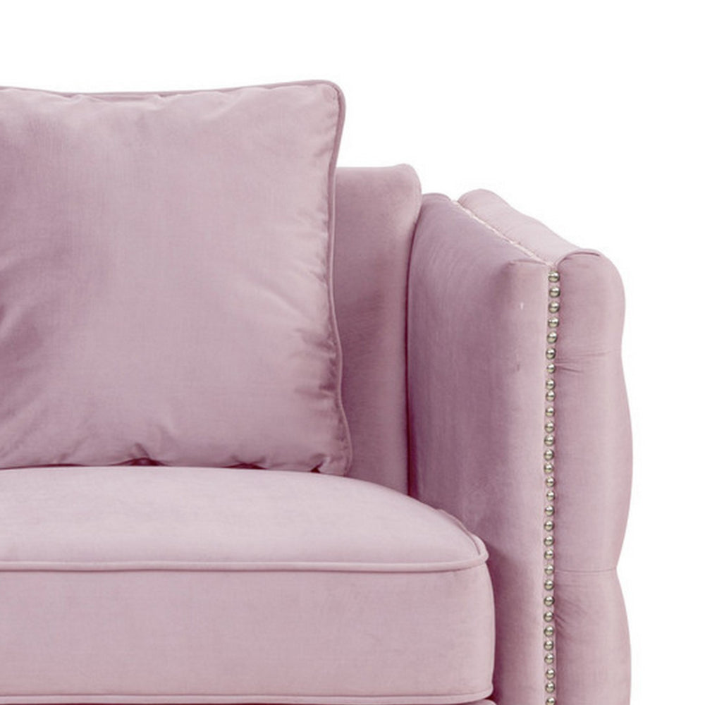 close-up of pink sofa's arm rest and pillow