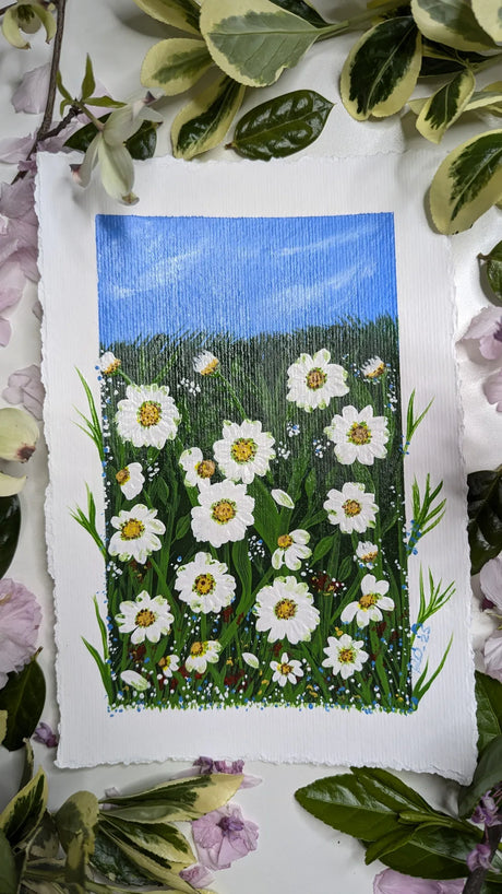 acrylic painting study of field of daisies beneath blue skies