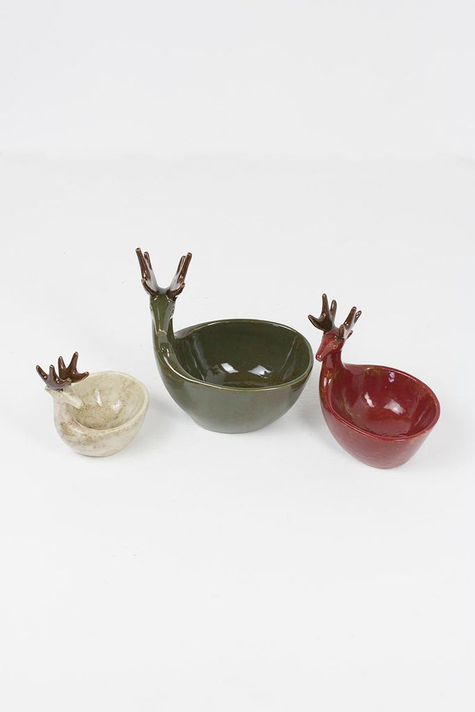 set of 3 ceramic deer bowls of different sizes in green, red and off-white colors - elevated view looking down