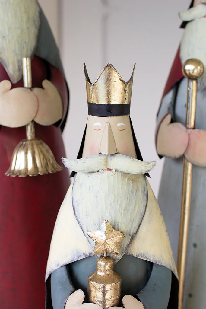 painted metal set of 3 kings - close-up of smallest king in front holding gift