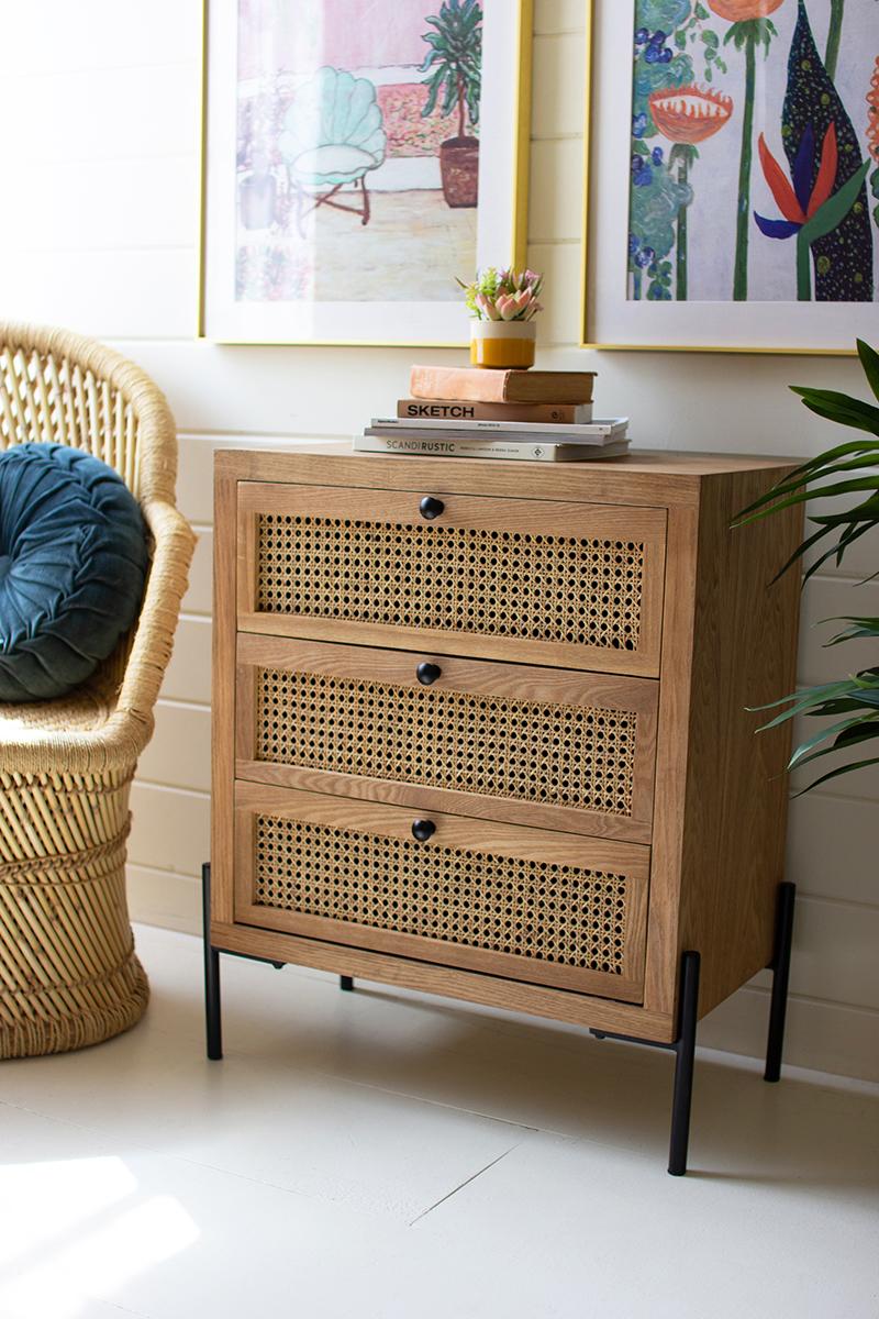 wood and woven cane nightstand on black metal legs with 3 drawers - front left view