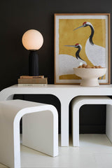 white wood coffee table with 2 smaller nested curved coffee tables with one extruded and standing at an angle closeup