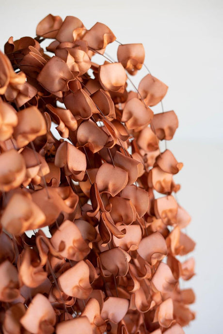 artificial plant with numerous light brown blossoms made with latex rubber - close-up view