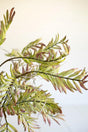 artificial plant with green branches and leaves made with latex rubber - close-up view