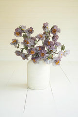 artificial plant with white and faint blue blossoms made with latex rubber - shown in white pot