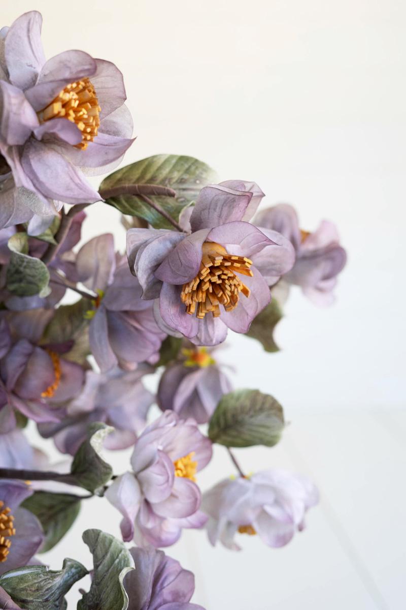 artificial plant with white and faint blue blossoms made with latex rubber - close-up view