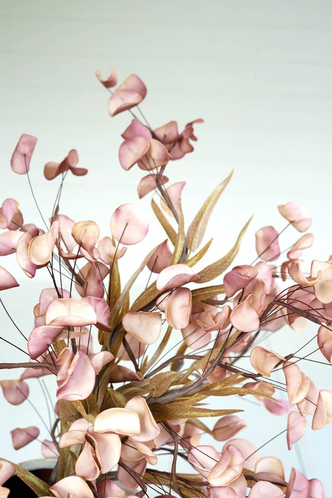 artificial plant with light brown blossoms made with latex rubber - close-up view