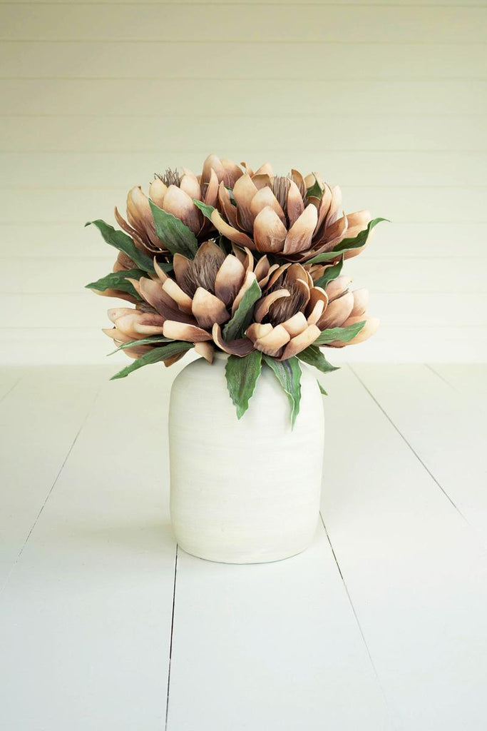 artificial plant with rusty orance flowers made with latex rubber - shown in white pot