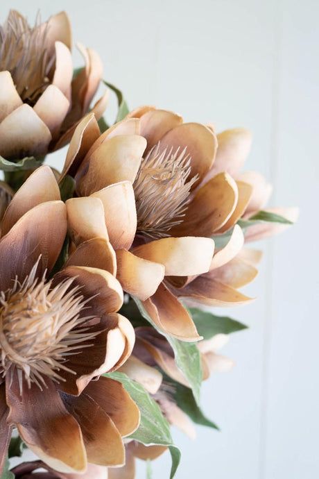 artificial plant with rusty orance flowers made with latex rubber - close-up view