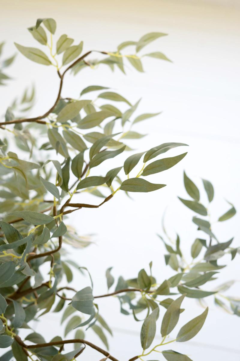 artificial plant with multiple branches and green leaves made with latex rubber - close-up view