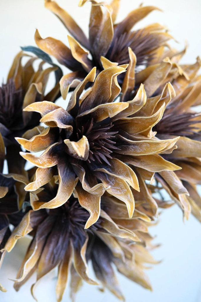 artificial plant with light brown flowers made with latex rubber - close-up view