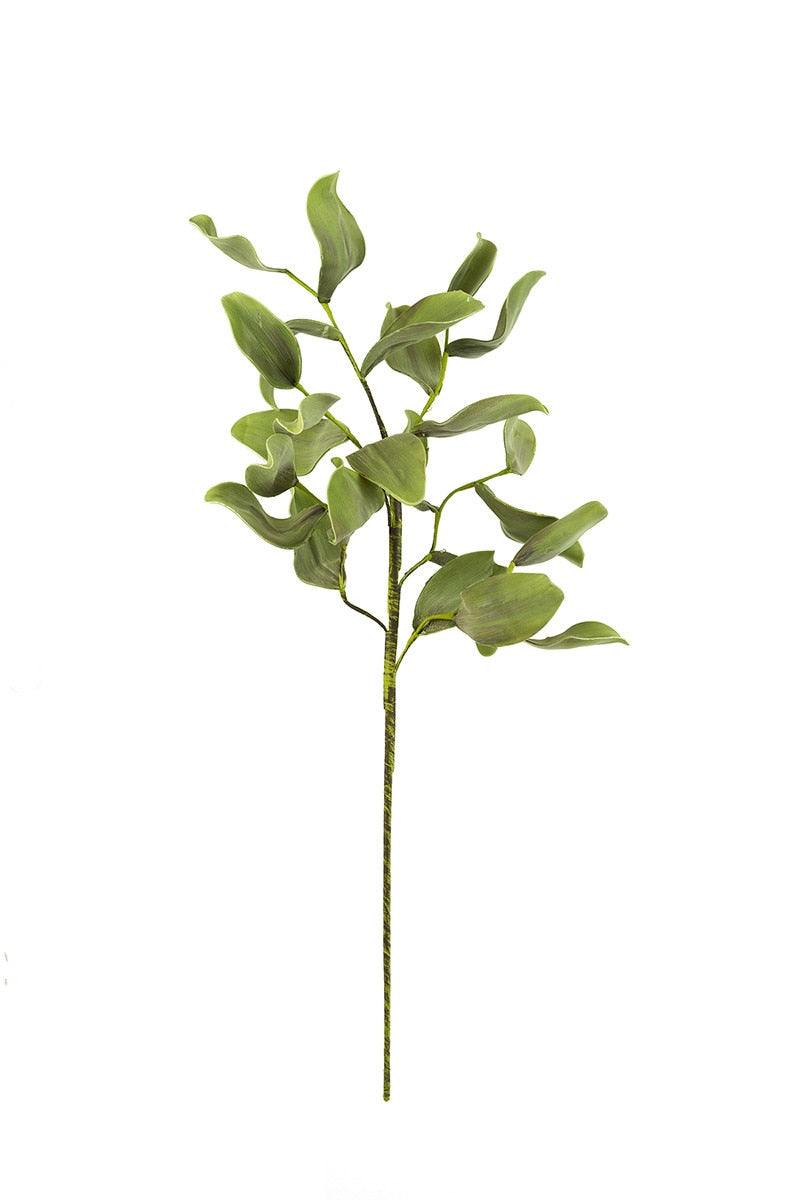 Artificial green leaf branch on a white background
