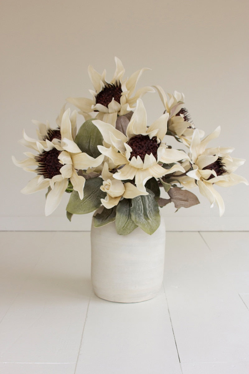 Bouquet of white flowers in a white vase on a light background