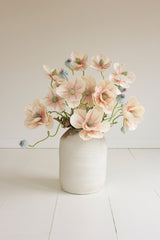 White vase with pink artificial flower bouquet