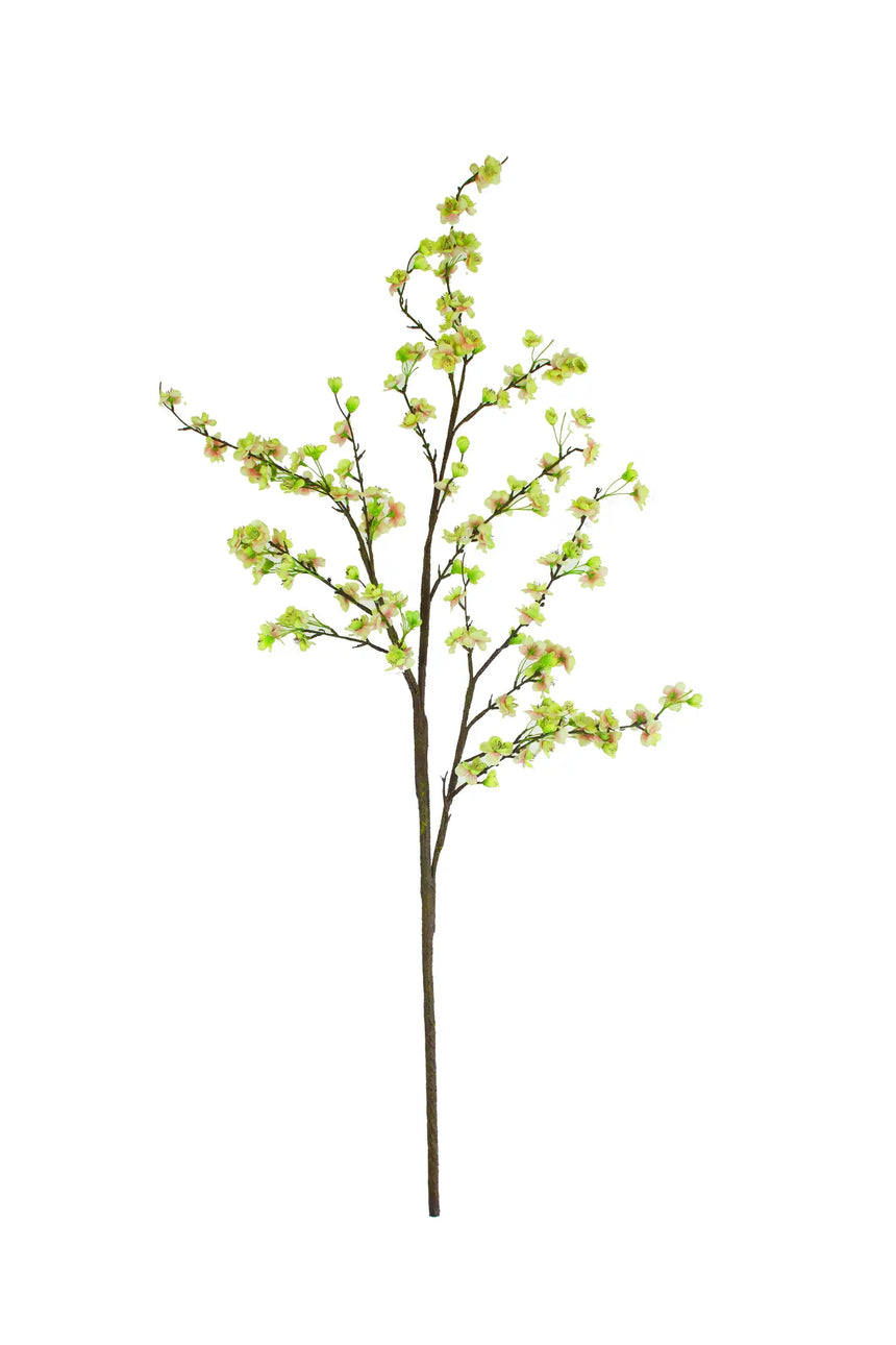 An artificial flowering blossom branch with light green leaves and small pale pink blossoms on a brown stem, isolated on a white background.