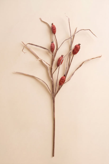 This tall faux botanical stem features slender branching lines accented with muted red berry-like details for an airy natural look.