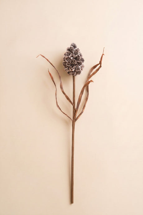 This sculptural faux stem features a textured pinecone-inspired accent paired with delicate branching details for a naturally collected woodland look.