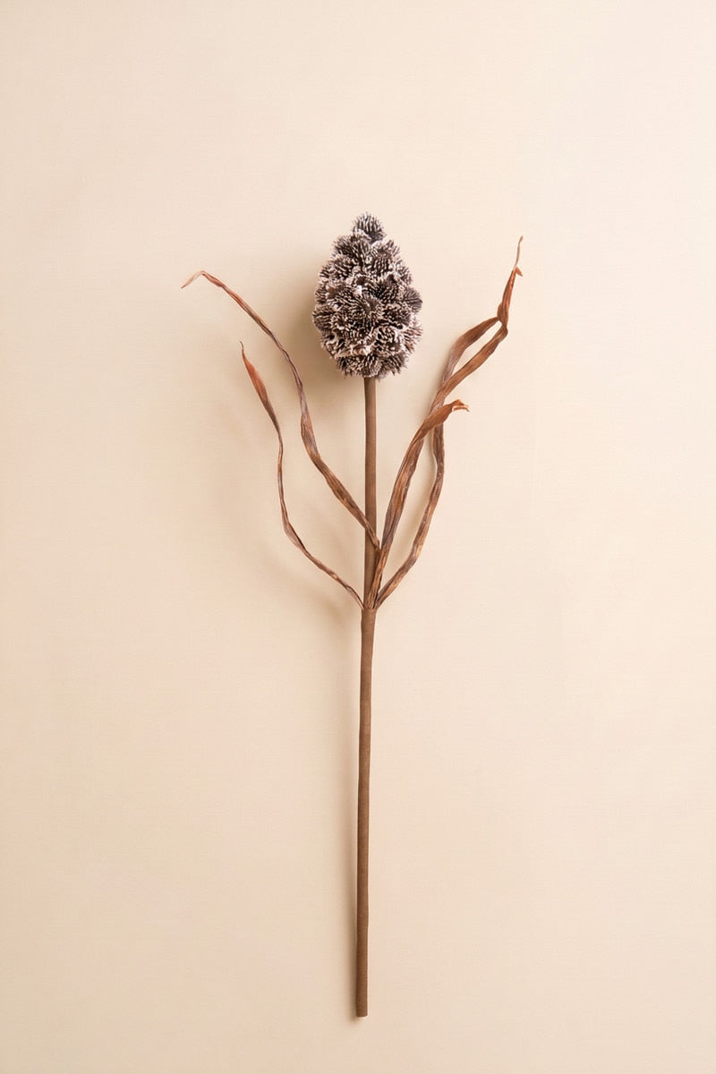 This sculptural faux stem features a textured pinecone-inspired accent paired with delicate branching details for a naturally collected woodland look.