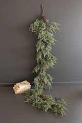 Long faux evergreen garland with pine cones