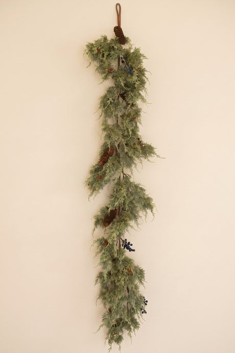 Long faux evergreen garland with pine cones and black berries