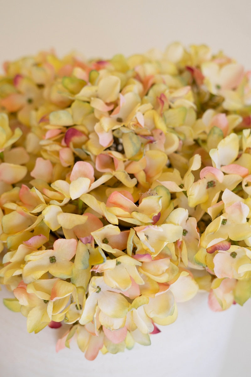 Close-up of faux blooms of yellow with pink accents