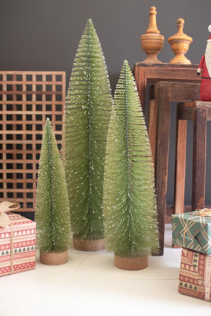 set of 3 bottle brush christmas trees of different sizes - shown with other rustic wood and gift décor
