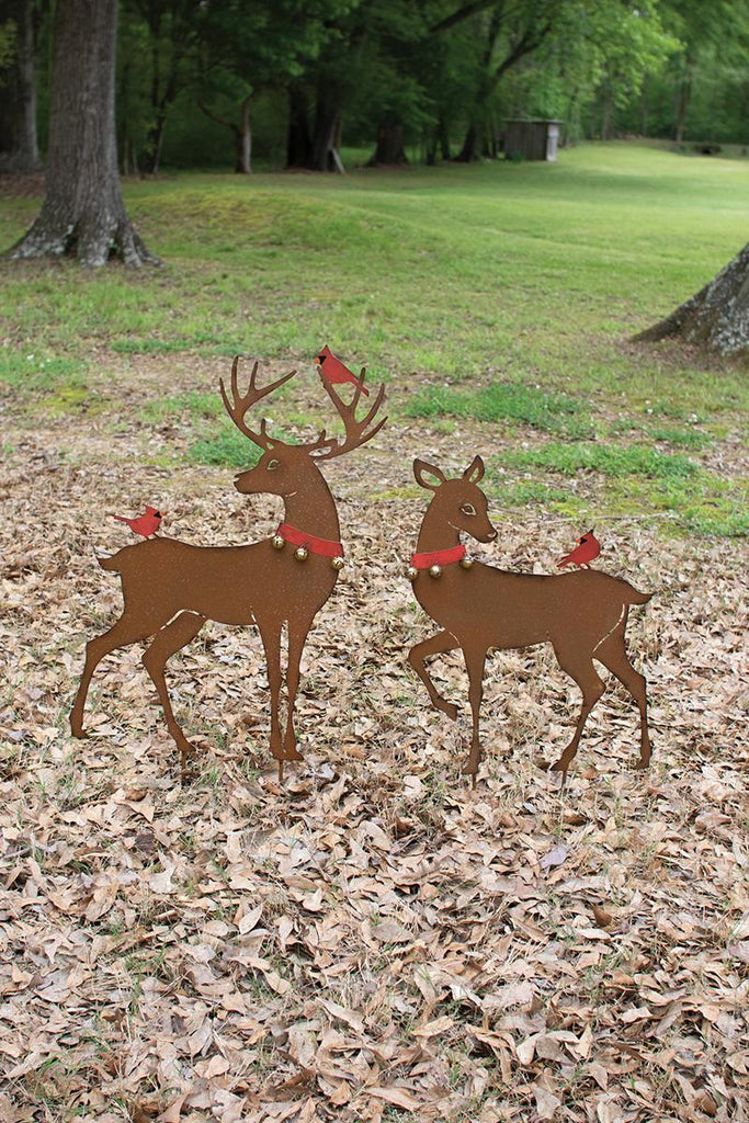 set of 2 yard art deer with red cardinal birds perched on them