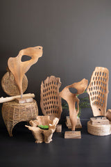 Collection of wooden sculptures and decorative items against a dark background