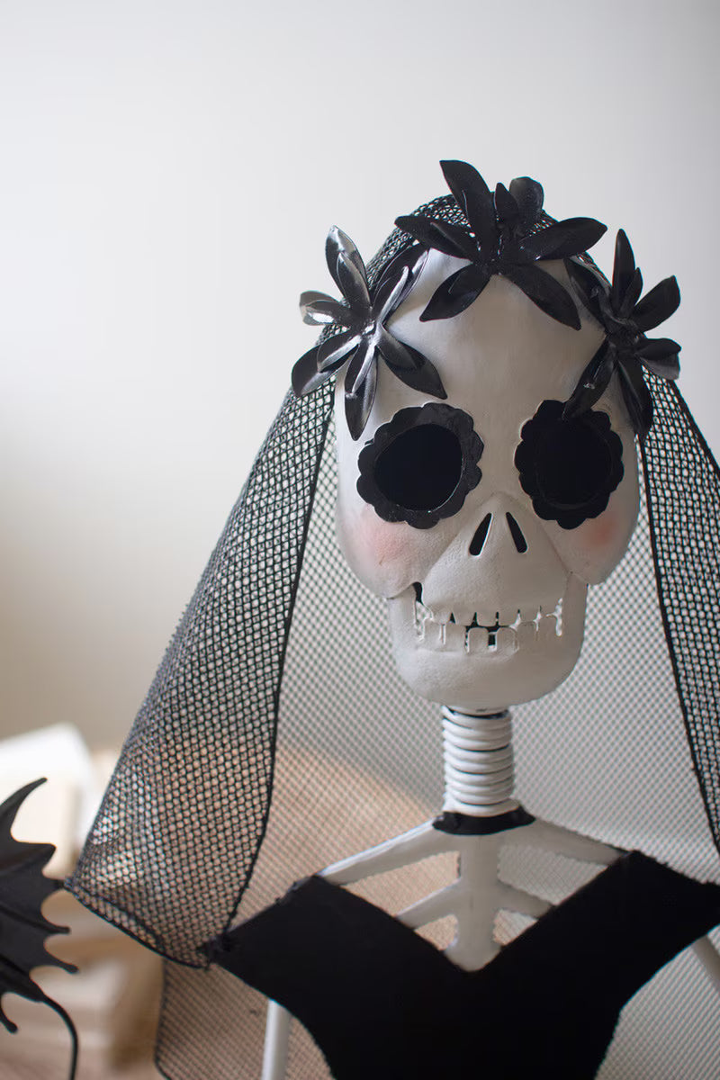 Skull with black flowers and a veil on a white background