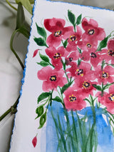 watercolor handpainted blue vase with red flowers on green stems - with plant background - zoomed in on flowers
