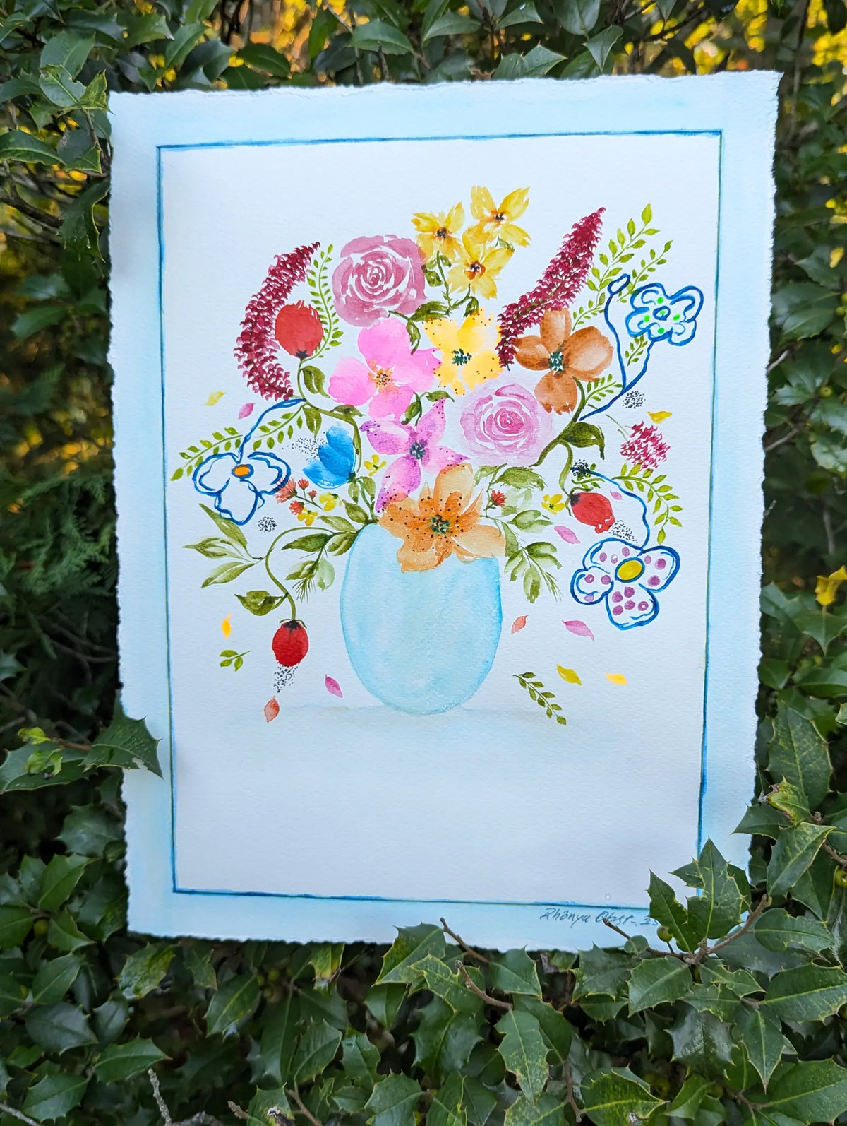 Original watercolor painting depicting a translucent blue glass vase holding a myriad of colorful flower bouquet.