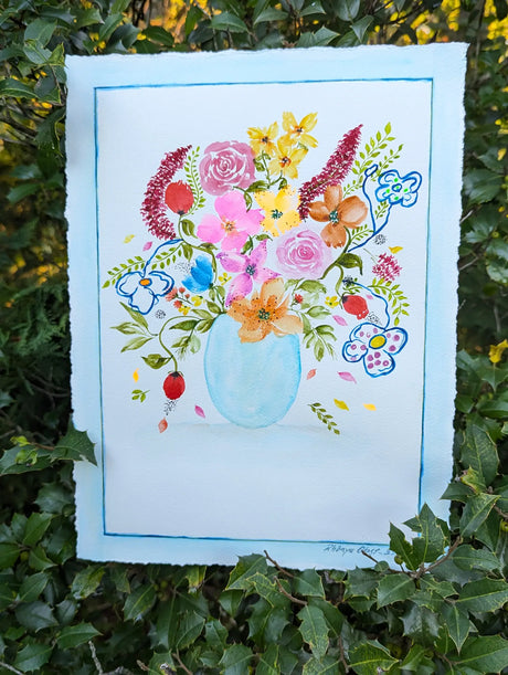 Original watercolor painting depicting a translucent blue glass vase holding a myriad of colorful flower bouquet.