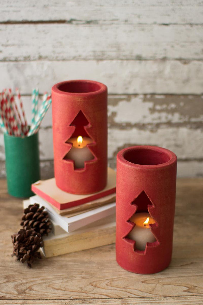red clay luminaries with christmas tree cutout showing candle light