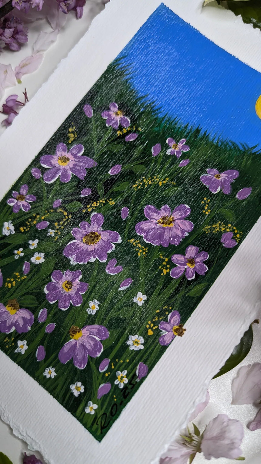 acrylic painting study of purple blossoms on green meadow against blue sky and bright sun - slanted right view