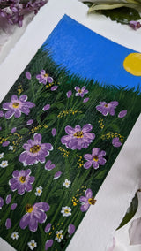 acrylic painting study of purple blossoms on green meadow against blue sky and bright sun - slanted right view 2