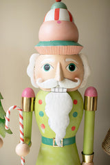 Decorative nutcracker figure with a colorful hat and holding a candy cane