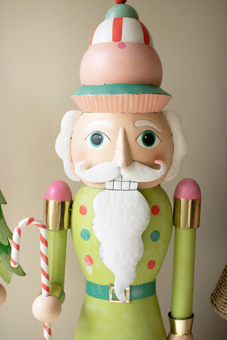 Decorative nutcracker figure with a colorful hat and holding a candy cane