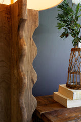 close-up of cross-shaped mango wood stand with wave detail